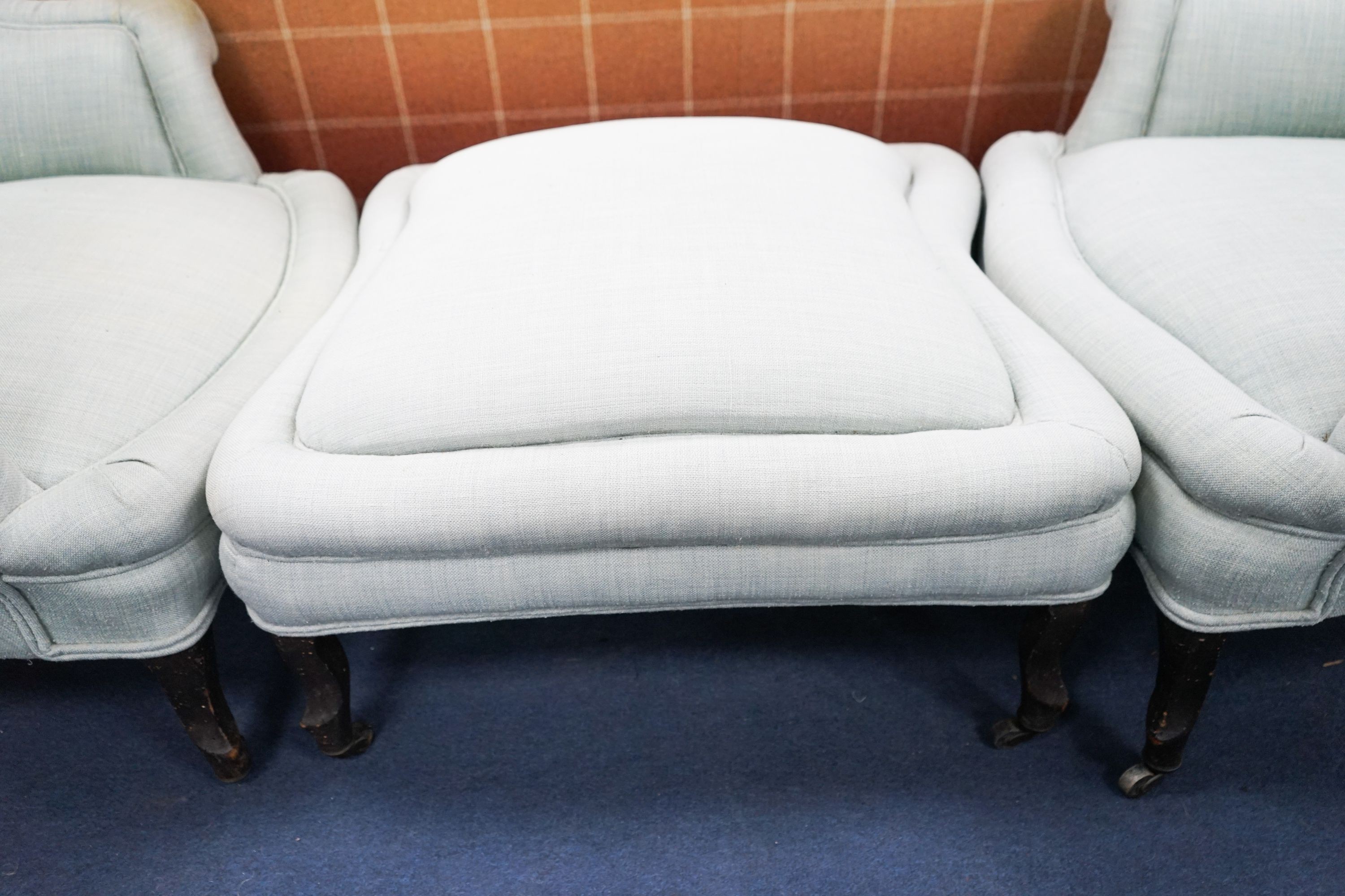 A French Duchesse Brisee comprising a pair of tub armchair and matching stool, on carved beech cabriole legs, chairs width 82cm